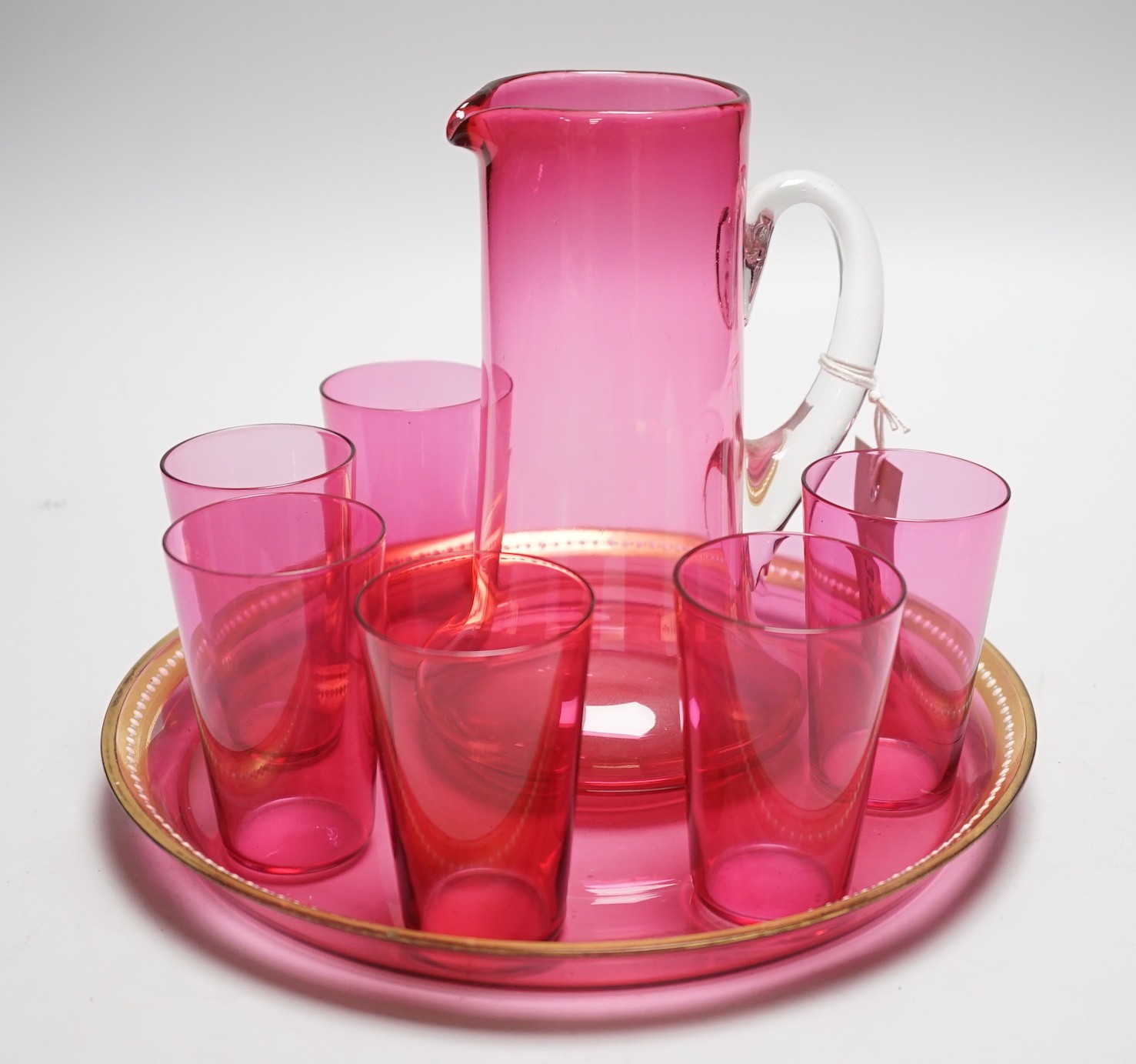 A cranberry glass lemonade six glass set, jug and tray